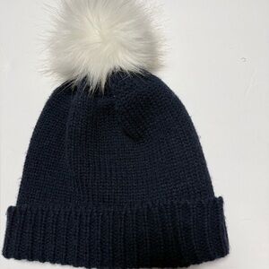 navy knit beanie with a faux fur pom pom